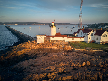 Eastern Point Lighthouse at sunrise in Gloucester, Massachusetts, USA. Aerial drone shot.の写真素材