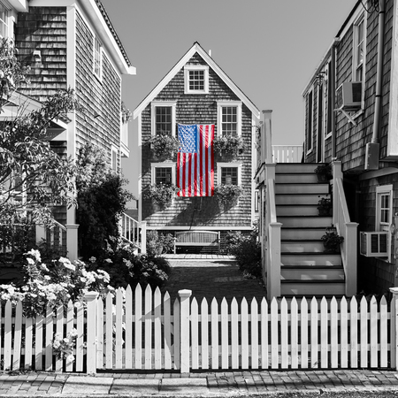 United States flag at suburban neighborhood. Provincetown, Cape Cod, Massachusetts, USA. Black and white image.の写真素材