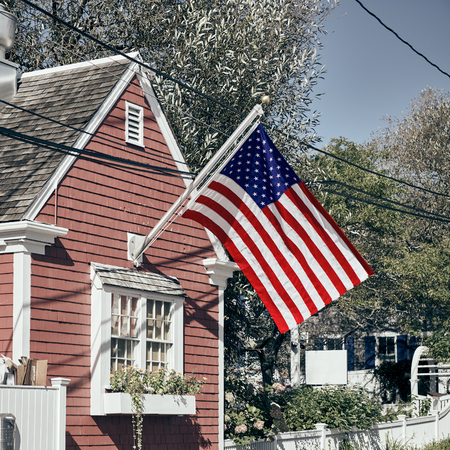 United States flag at suburban neighborhood. Provincetown, Cape Cod, Massachusetts, USA.の写真素材