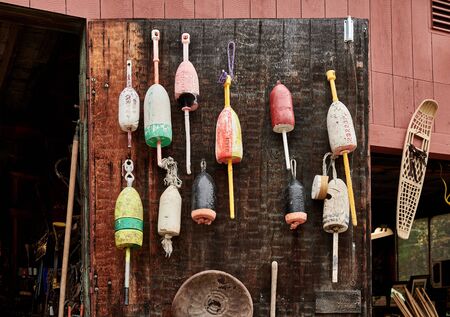 Fishing buoys handing on wooden wall at flea marketの写真素材