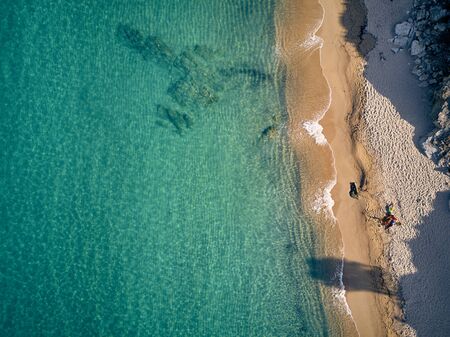 Beautiful beach with family top aerial view drone shot, Sithonia, Greeceの写真素材