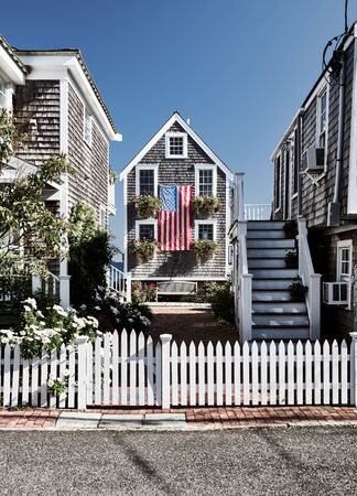 United States flag at suburban neighborhood. Provincetown, Cape Cod, Massachusetts, USA.の写真素材