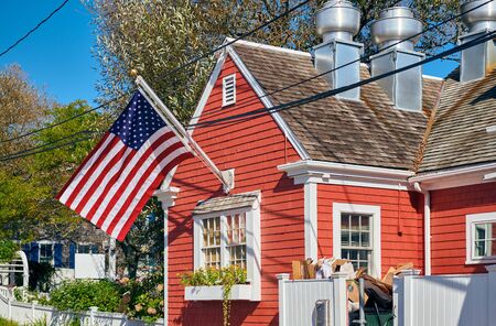 United States flag at suburban neighborhood. Provincetown, Cape Cod, Massachusetts, USA.の写真素材