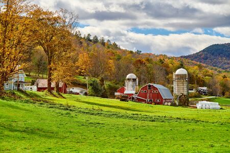 Farm with red barn and silos at sunny autumn day in West Arlington, Vermont, USA