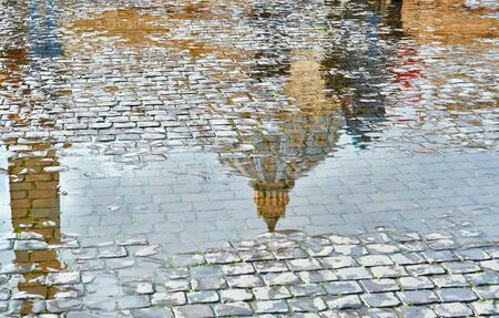 Cobblestone brick paved wet street with Saint Peter's Basilica reflection in Rome, Italyの写真素材