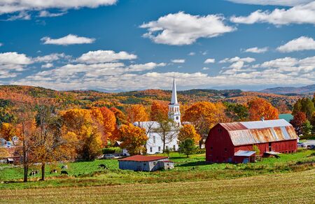 Congregational Church and farm with red barn at sunny autumn day in Peacham, Vermont, USAの写真素材