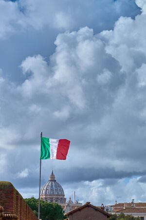 St. Peter's cathedral view from Castle of the Holy Angel (Castel Sant'Angelo) and flag of Italy in Romeの写真素材