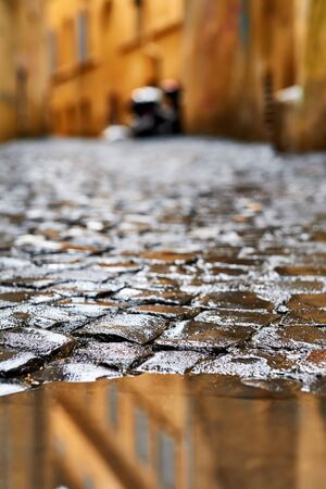 Cobblestone brick paved wet street in Rome, Italyの写真素材