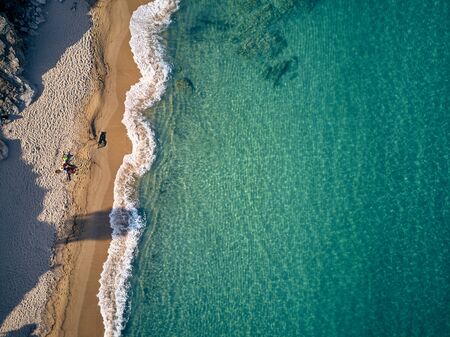 Beautiful beach with family top aerial view drone shot, Sithonia, Greeceの写真素材