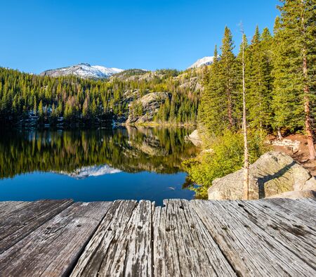Bear Lake and reflection with mountains in snow around at autumn. Rocky Mountain National Park in Colorado, USA.の写真素材