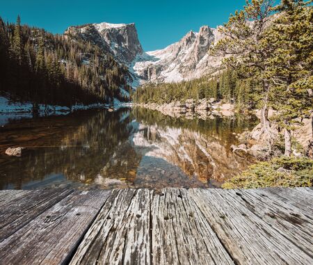 Dream Lake and reflection with mountains in snow around at autumn. Rocky Mountain National Park in...