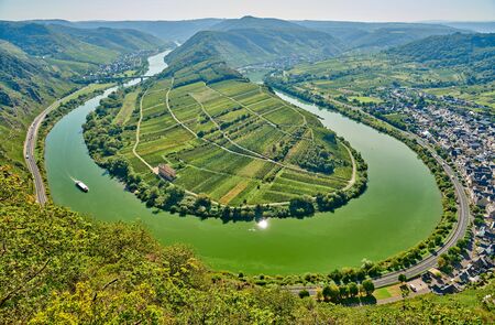 Moselle River bend near Bremm town, Germany. Hills with vineyards, river loop and road along the river. Meander of the Moselle.の写真素材