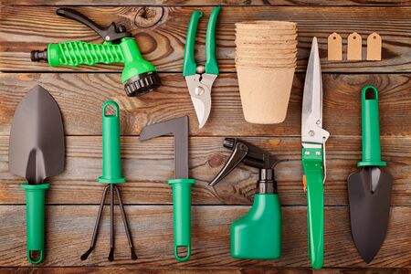 Gardening tools on wooden background flat lay top viewの写真素材