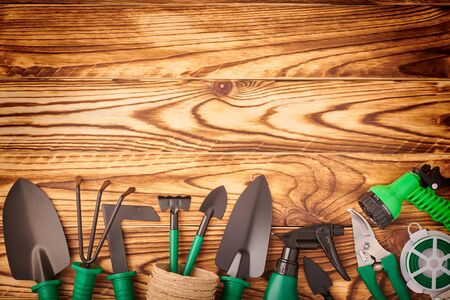 Gardening tools on wooden background flat lay top viewの写真素材
