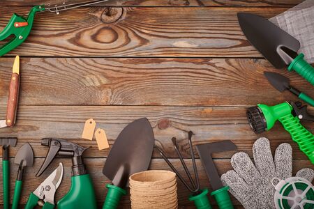 Gardening tools on wooden background flat lay top viewの写真素材