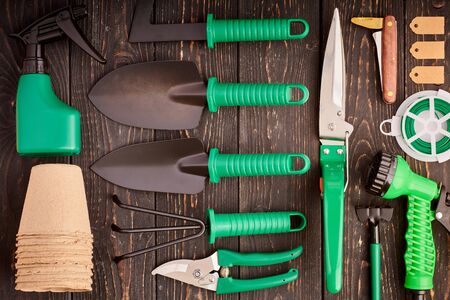 Gardening tools on wooden background flat lay top viewの写真素材