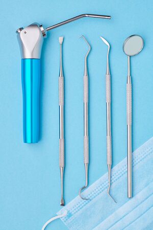 Dentist tools over light blue background top view flat lay. Tooth care, dental hygiene and health concept.の写真素材