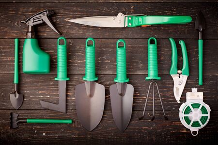 Gardening tools on wooden background flat lay top viewの写真素材