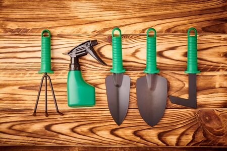 Gardening tools on wooden background flat lay top viewの写真素材