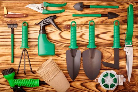 Gardening tools on wooden background flat lay top viewの写真素材