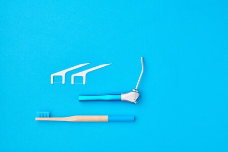 Dentist tools over blue background top view copy space flat lay. Tooth care, dental hygiene and health concept.の写真素材