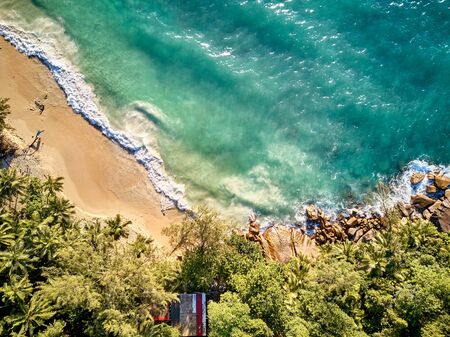 Beautiful beach with palm trees aerial top view drone shot at Seychelles, Maheの写真素材