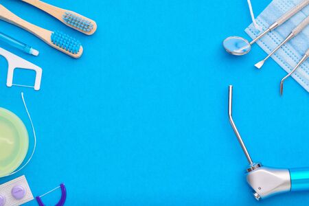 Dentist tools over blue background top view copy space flat lay. Tooth care, dental hygiene and health concept. の写真素材