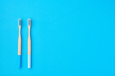 Toothbrushes on blue background top view copy space. Tooth care, dental hygiene and health concept. の写真素材