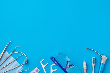 Dentist tools over blue background top view copy space flat lay. Tooth care, dental hygiene and health concept. の写真素材