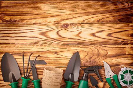 Gardening tools on wooden background flat lay top view の写真素材