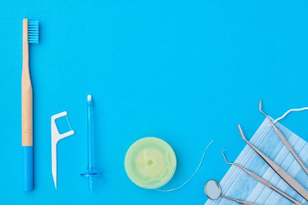 Dentist tools over blue background top view flat lay. Tooth care, dental hygiene and health concept. の写真素材
