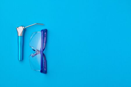 Dentist tools over blue background top view copy space flat lay. Tooth care, dental hygiene and health concept. の写真素材