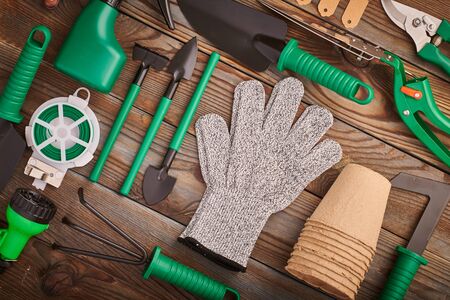 Gardening tools on wooden background flat lay top view の写真素材