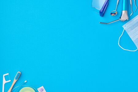 Dentist tools over blue background top view copy space flat lay. Tooth care, dental hygiene and health concept. の写真素材