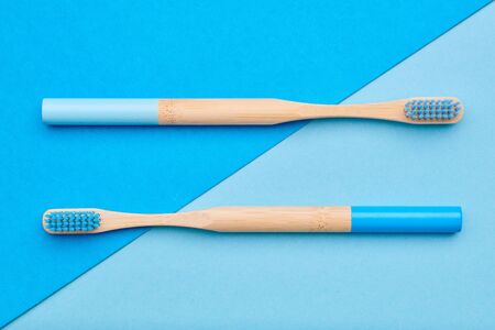 Toothbrushes on blue background top view. Tooth care, dental hygiene and health concept. の写真素材
