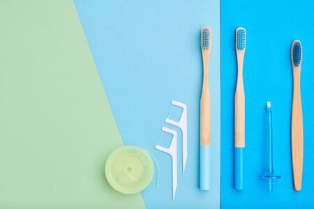 Toothbrushes and oral care tools over blue background top view copy space flat lay. Tooth care, dental hygiene and health concept. の写真素材