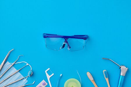Dentist tools over blue background top view copy space flat lay. Tooth care, dental hygiene and health concept. の写真素材