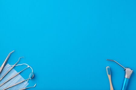 Dentist tools over blue background top view copy space flat lay. Tooth care, dental hygiene and health concept. の写真素材