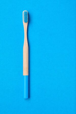 Toothbrush on blue background top view copy space. Tooth care, dental hygiene and health concept. の写真素材