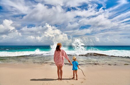 Three year old toddler boy on beach with mother. Summer family vacation at at Seychelles, Mahe.の写真素材