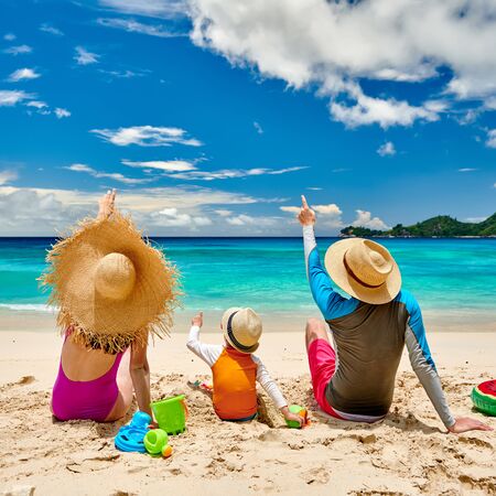 Family on beach, young couple with three year old boy. Summer vacation at Seychelles.の写真素材