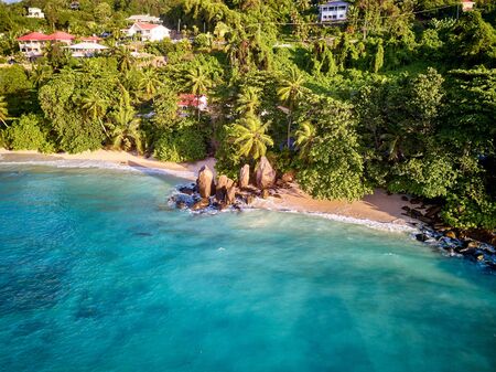 Beautiful beach with palm trees aerial top view drone shot at Seychelles, Maheの写真素材
