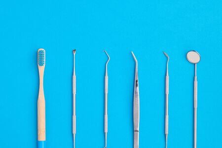 Dentist tools over blue background top view flat lay. Tooth care, dental hygiene and health concept. の写真素材