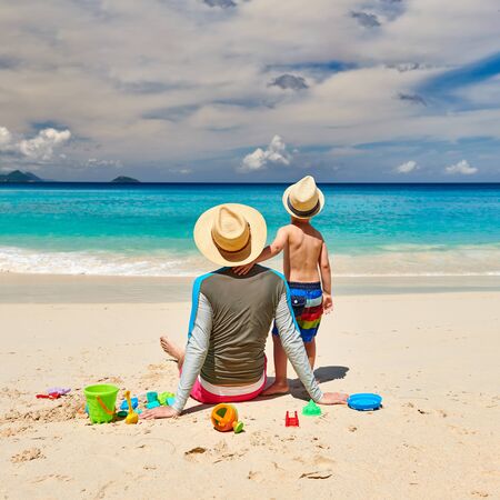 Three year old toddler boy on beach with father. Summer family vacation at at Seychelles, Mahe.の写真素材