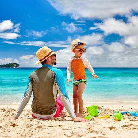 Three year old toddler boy on beach with father. Summer family vacation at at Seychelles, Mahe.の写真素材