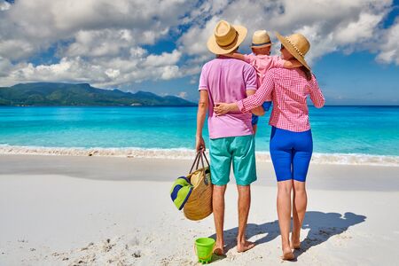 Family on beautiful Anse Soleil beach, young couple with three year old toddler boy. Summer vacation at Seychelles, Mahe.の写真素材