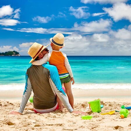 Three year old toddler boy on beach with father. Summer family vacation at at Seychelles, Mahe.の写真素材