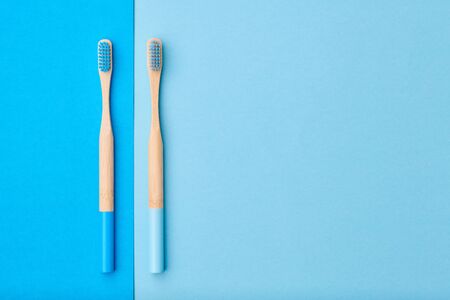 Toothbrushes on blue background top view copy space. Tooth care, dental hygiene and health concept. の写真素材