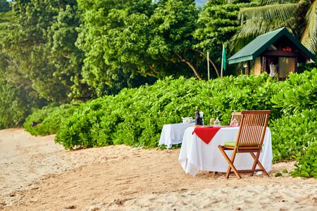 Table set up for romantic dinner on beach at Mahe, Seychellesの写真素材