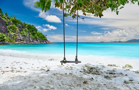 Beautiful Petite Anse beach with swing at Mahe, Seychellesの写真素材